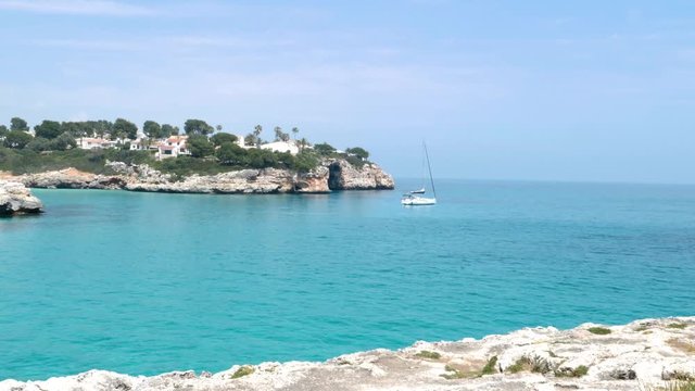 A sailing boat in a beaitiful creek in Baleares, Spain
