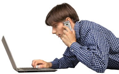 Portrait of young handsome man using laptop and phone isolated