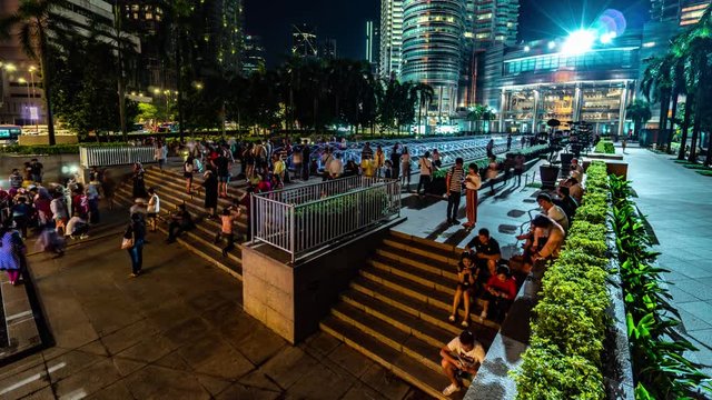 KUALA LUMPUR, MALAYSIA - May 15, 2018: Fountain at night with peoples near Petronas twin tower 4K