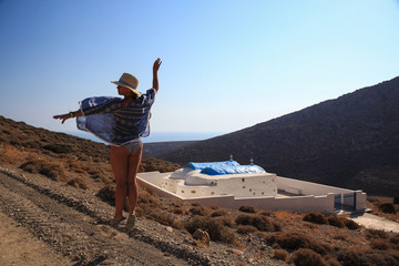 Girl performing a pirouette overlooking a greek church © Adam