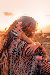 close up of beautiful young woman at sunset