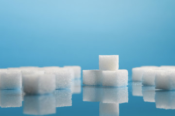 Group of Sugar cubes vary position on light blue background