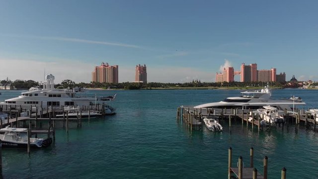 4K Cinematic Aerial flyover past yachts and boats in the marina right in front of the Atlantis hotel.
