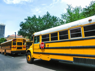 Fototapeta na wymiar The traditional school buss on freeway road at Orlando, Florida, USA