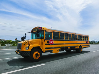 Fototapeta na wymiar The traditional school buss on freeway road at Orlando, Florida, USA