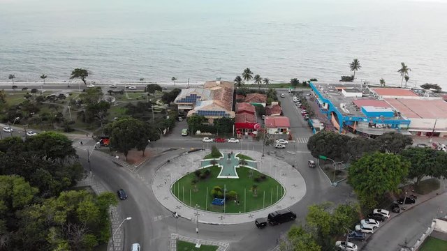 4K Cinematic Aerial footage flying over the top of the central square which includes the statue of Pedro &Aacute;lvares Cabral and sign that welcomes people to Porto Seguro, Brazil.