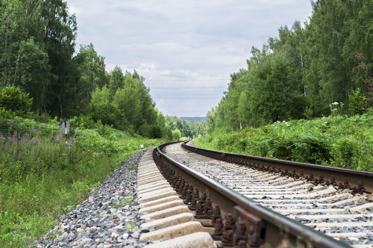 Railway track in the forest on a summer day