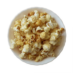 Popcorn in a white ceramic bowl on a white background. Top view, square. Isolate.