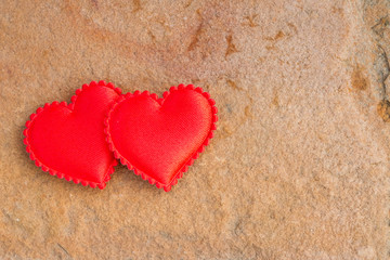 Red heart on the brown stone.