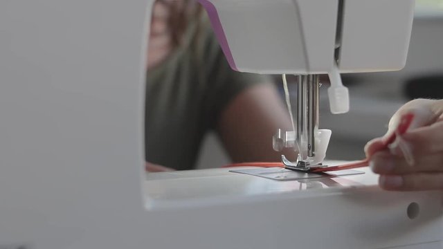 Sewing at home with machine.