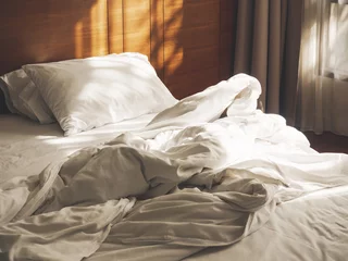 Foto op Aluminium Bed Mattress and Pillows unmade Bedroom Hotel Morning with sunlight © VTT Studio