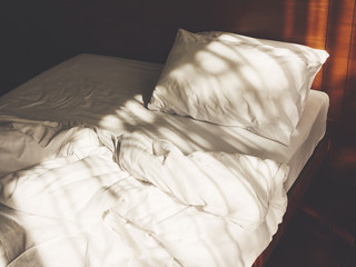 Bed Mattress and Pillows unmade Hotel Bedroom Morning with sunlight
