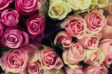 Obraz na płótnie Canvas Beautiful fresh bouquet. Natural roses background. Retro filter. Festive assorted roses. Various soft roses top view. Unfocused blur rose, abstract romance background, flower card. Selective focus.