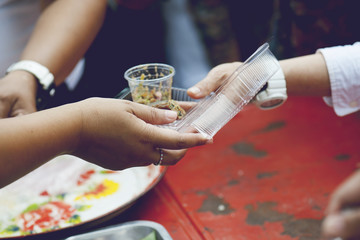 hands of the poor receive food from the donor's share. poverty concept