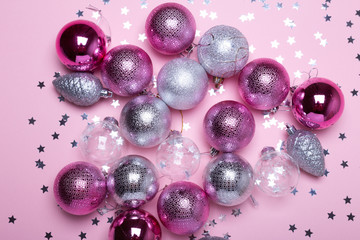 Pink and silver christmas decorations on a paper background