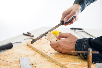 Carpenter working carefully looking at the plans work in carpentry. He is successful entrepreneur at his workplace. hammering a nail Supports On Building Site work with cutter.