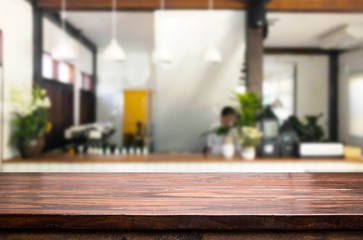 Selected focus empty brown wooden table and Coffee shop or restaurant blur background with bokeh image. for your photomontage or product display