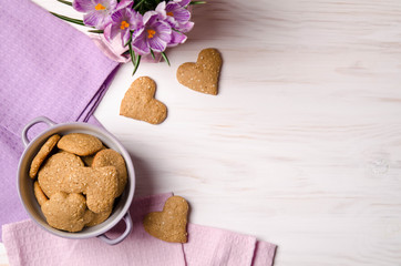 Sesame dry cookies in the form of heart on a wooden table