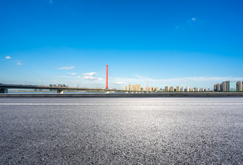 empty asphalt raod with city skyline