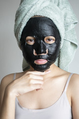 Beautiful woman with Black  facial mask, Lifestyle concept