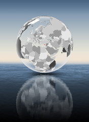 Cyprus on translucent globe above water