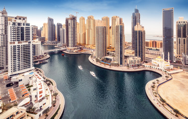 Aerial daytime skyline of Dubai Marina, UAE, with skyscrapers in the distance. Scenic travel background.
