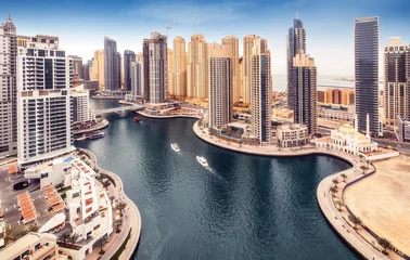 Fototapeten Aerial daytime skyline of Dubai Marina, UAE, with skyscrapers in the distance. Scenic travel background. © Funny Studio