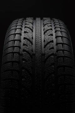 Close-up Of Car Tire Over Black Background