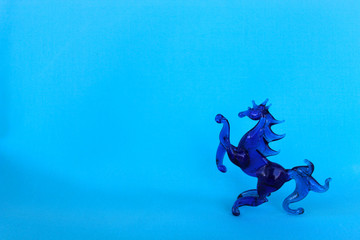 Glass horse on a blue background