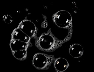 Soap foam with bubbles isolated on black background, with clipping path texture, top view