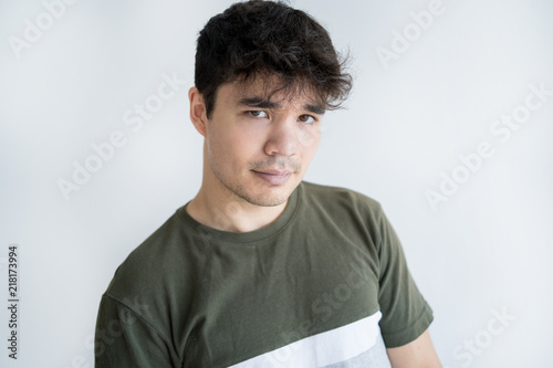 Portrait of confident young Asian man looking at camera. Vietnamese male model posing in studio Portrait of confident young Asian man looking at camera. Vietnamese ...