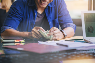 business, finance, close up of Happiness businessman counting us dollar money for investment.