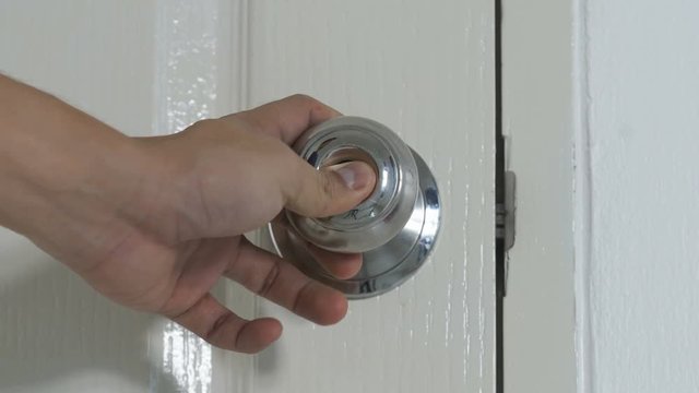 hand closing and locking the door knob