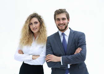 two young business people stand with arms folded