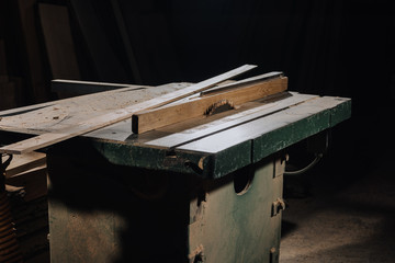 Fototapeta na wymiar close up view of circular saw and materials at wooden workshop