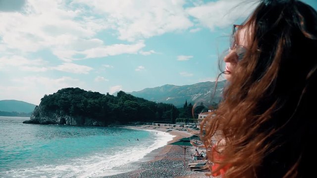 Beautiful brunnete woman in red bikini sunbathes on the beach