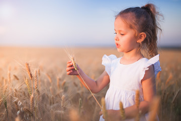 Happy Little Girl Outdoor At Wheat Field. End of Summer