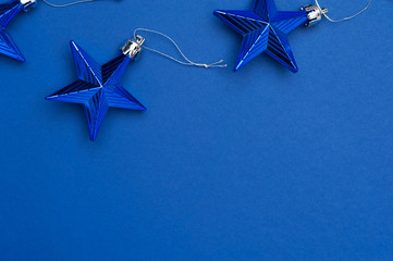 Christmas decoration stars on blue background. Merry Christmas and Happy New Year. Top view, place...