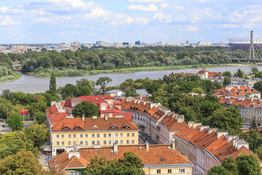 Fototapeta View from viewing terrace on tower of church of St. Anna on part of city called Mariensztat and on Vistula with Praga district located on other bank 