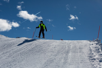 Ten Year Little Skier Having Fun skiing in Italian Dolomites Alps Mountains