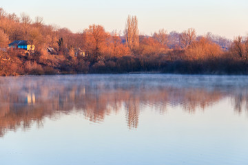 View on the peaceful lake and village at morning