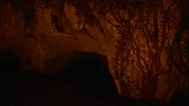 Old tuff caves with shadows from a fire in the night