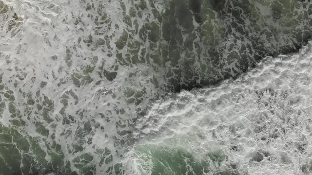 The take-off of a drone over the waves and the beach during a storm