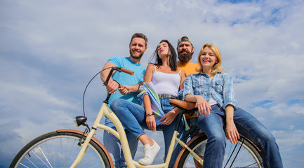 Youth likes cruiser bike. Cycling modernity and national culture. Company stylish young people spend leisure outdoors sky background. Group friends hang out with bicycle. Bicycle as best friend