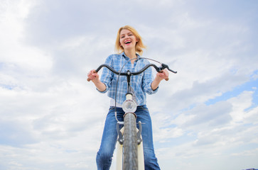 Woman likes to ride bike. Girl enjoy short cycle tour with stop offs along way and travel. Girl holds handlebar of bike. Leisure cycling is about seeing exploring and visiting new places on bicycle