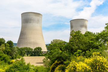 Two natural draft cooling towers of a nuclear power plant releasing clouds of water vapor in the...