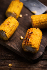 Grilled corn on wooden table