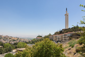 Fototapeta na wymiar Panorama of the Bekaa Valley in Lebanon, with Our Lady of the Bekaa church and statue over the town of Zahlé.