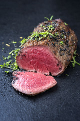 Traditional barbecue dry aged wagyu fillet steak with herb and spice marinated as closeup on a...