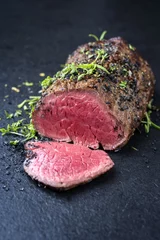 Fotobehang Traditional barbecue dry aged wagyu fillet steak with herb and spice marinated as closeup on a black board © HLPhoto